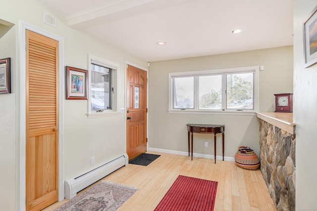 foyer with light wood-style flooring, a baseboard heating unit, baseboards, and recessed lighting