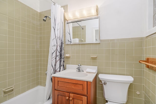 bathroom with toilet, tile walls, shower / tub combo with curtain, and vanity