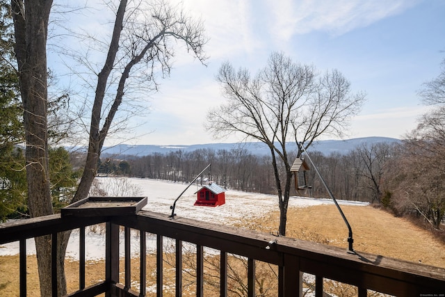 exterior space with a wooded view and a mountain view