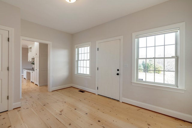 entryway featuring visible vents, light wood-style flooring, and baseboards