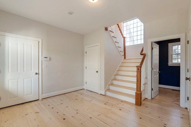 stairs with baseboards and wood-type flooring