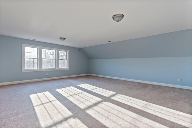 bonus room featuring vaulted ceiling, carpet, baseboards, and visible vents