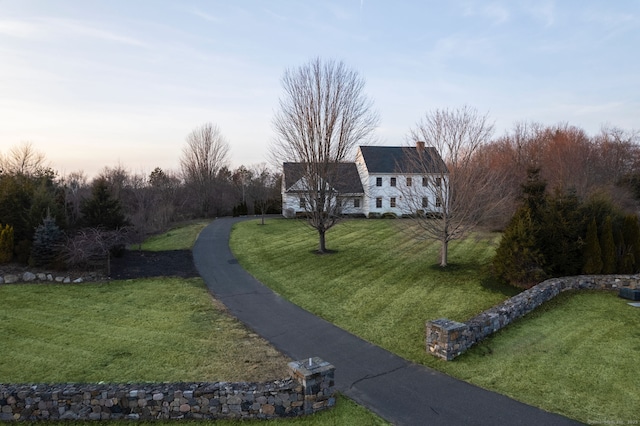 view of front of house with a lawn and a chimney