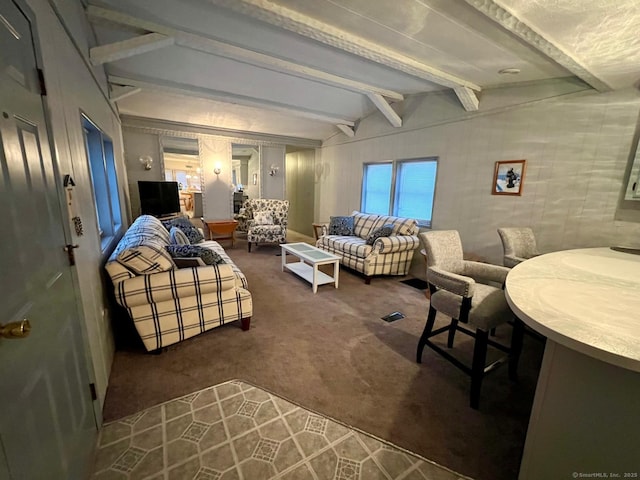 living room with beam ceiling and dark colored carpet