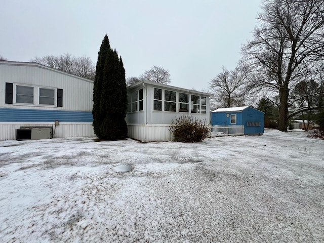 view of snowy exterior with central AC