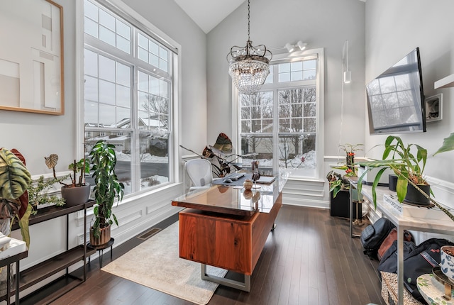 home office with dark wood-style floors, visible vents, high vaulted ceiling, and an inviting chandelier