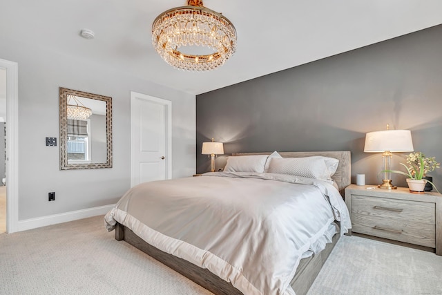 bedroom with light carpet, an inviting chandelier, and baseboards