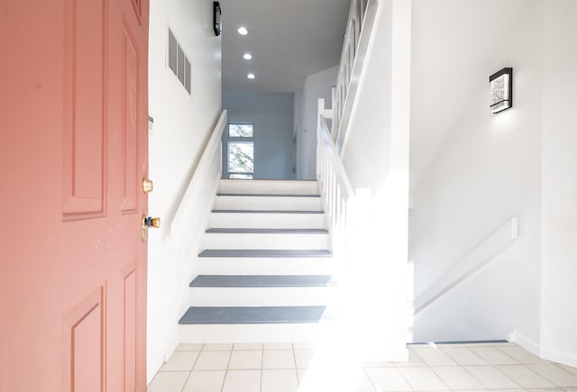 stairs with tile patterned floors