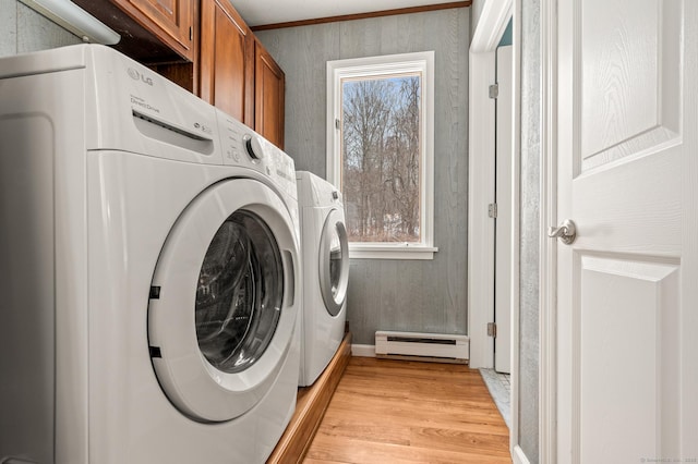 laundry room with separate washer and dryer, a baseboard radiator, cabinets, and light wood-type flooring