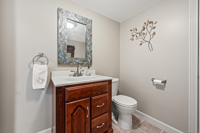 bathroom featuring tile patterned floors, vanity, and toilet