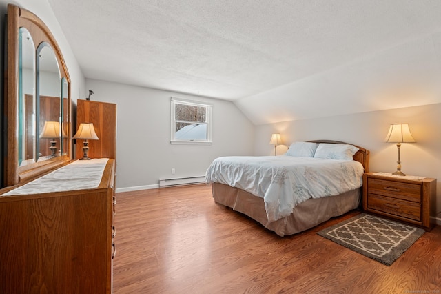 bedroom with a baseboard radiator, lofted ceiling, a textured ceiling, and light hardwood / wood-style floors