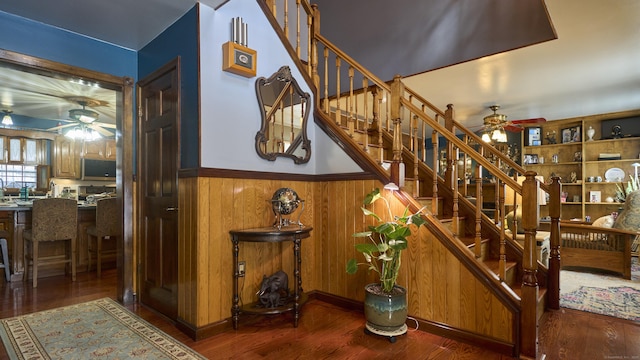 49 Quinebaug Ave, Putnam, CT 06260 - stairway featuring a ceiling fan, a wainscoted wall, wood finished floors, and wood walls
