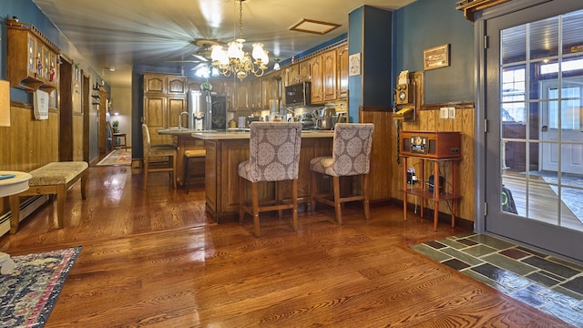 49 Quinebaug Ave, Putnam, CT 06260 - kitchen with stainless steel fridge, a chandelier, dark wood finished floors, a peninsula, and a breakfast bar area