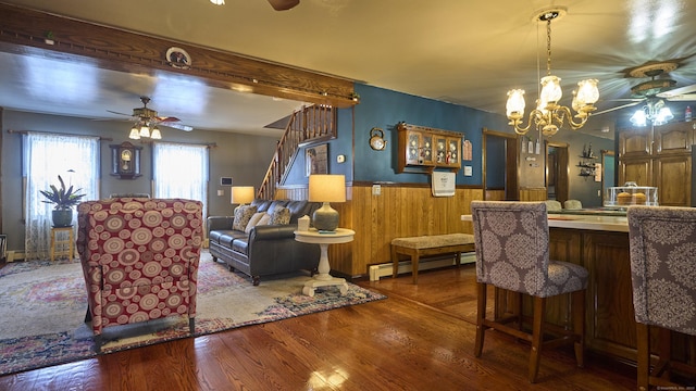 49 Quinebaug Ave, Putnam, CT 06260 - dining room featuring a ceiling fan, a baseboard heating unit, wainscoting, wood finished floors, and wood walls