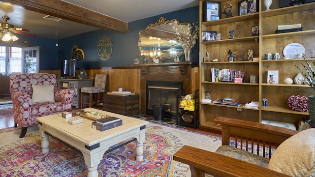 49 Quinebaug Ave, Putnam, CT 06260 - living room with a fireplace with flush hearth, ceiling fan, wainscoting, and beam ceiling