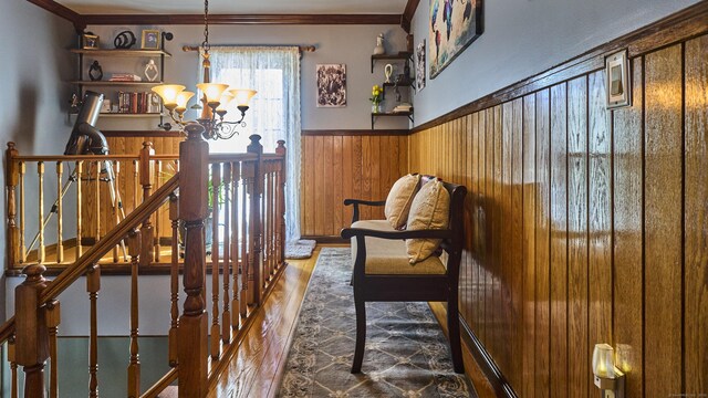 49 Quinebaug Ave, Putnam, CT 06260 - sitting room featuring wood finished floors, a chandelier, wainscoting, crown molding, and wood walls