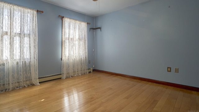 49 Quinebaug Ave, Putnam, CT 06260 - empty room with wood-type flooring, plenty of natural light, and baseboards