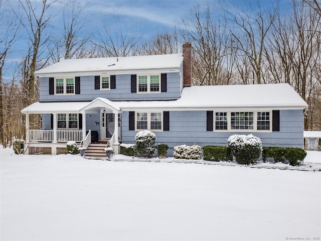 view of front facade featuring a porch and a chimney