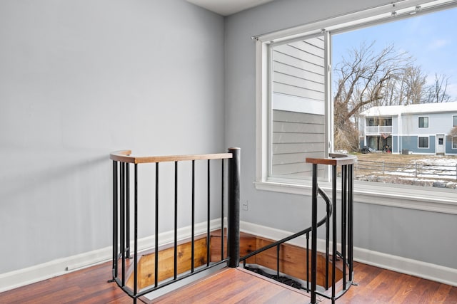 stairs with baseboards and wood finished floors