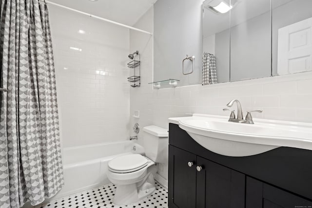 full bath featuring tile patterned flooring, toilet, shower / tub combo, vanity, and tile walls