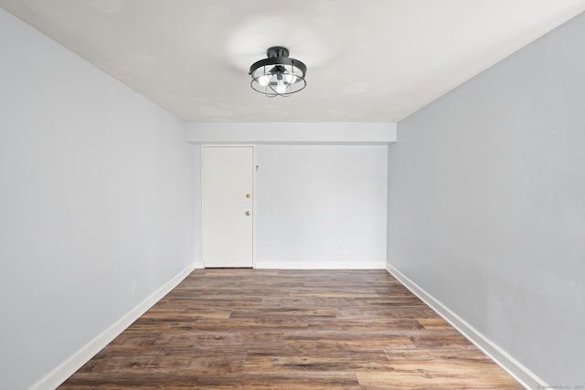 empty room featuring baseboards and wood finished floors