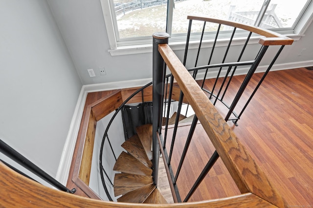 stairs featuring baseboards and wood finished floors