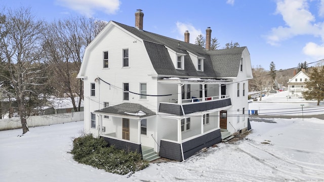 view of snowy exterior with a balcony