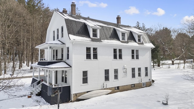 view of snowy exterior with covered porch