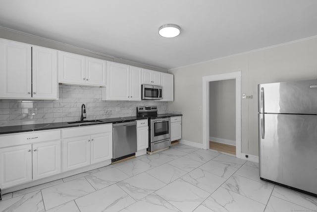 kitchen with sink, crown molding, white cabinets, and appliances with stainless steel finishes