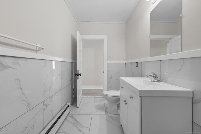 bathroom with vanity, a baseboard heating unit, tile walls, and toilet