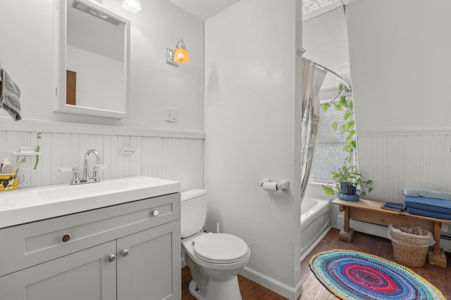 full bathroom with vanity, hardwood / wood-style floors, shower / bath combination with curtain, and toilet