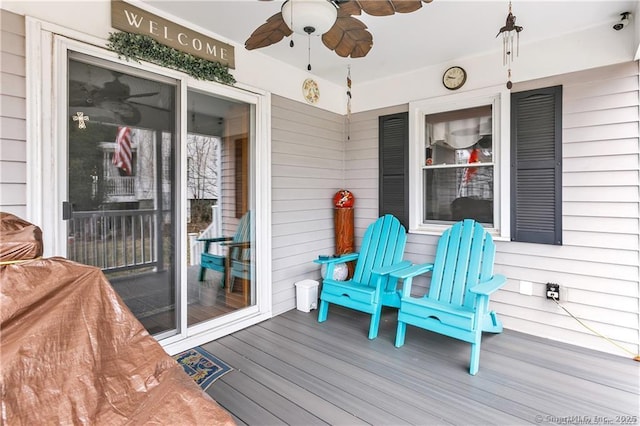 wooden deck featuring ceiling fan