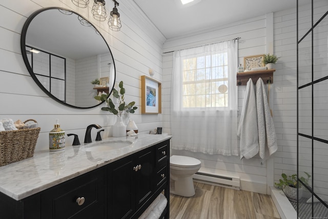 full bath with wood finished floors, baseboard heating, vanity, and toilet