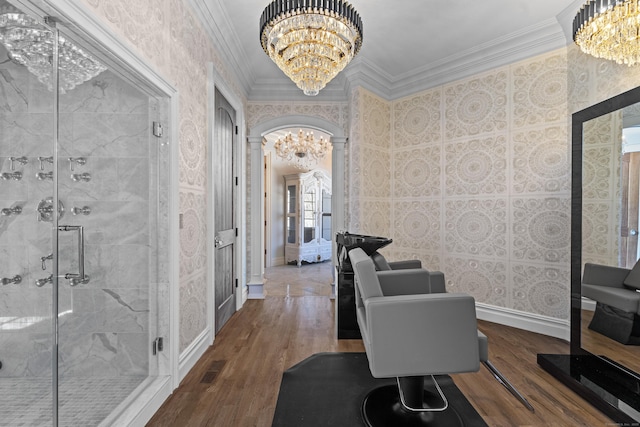 office area featuring wallpapered walls, a chandelier, crown molding, and wood finished floors