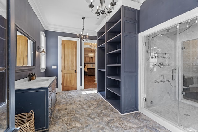 full bathroom with a chandelier, a shower stall, vanity, and crown molding