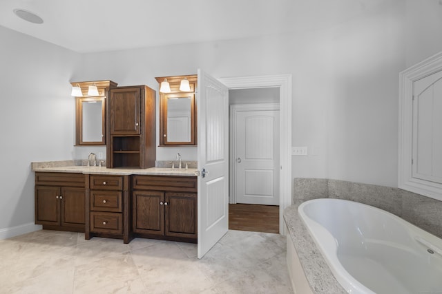 full bathroom featuring a bath, double vanity, and a sink