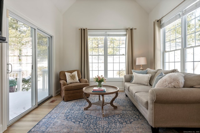 sitting room with light hardwood / wood-style floors and vaulted ceiling