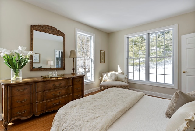 bedroom featuring multiple windows and hardwood / wood-style floors