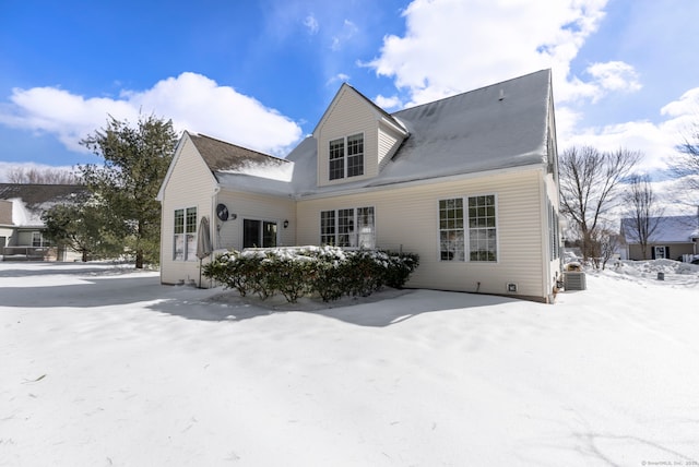 snow covered property featuring central air condition unit