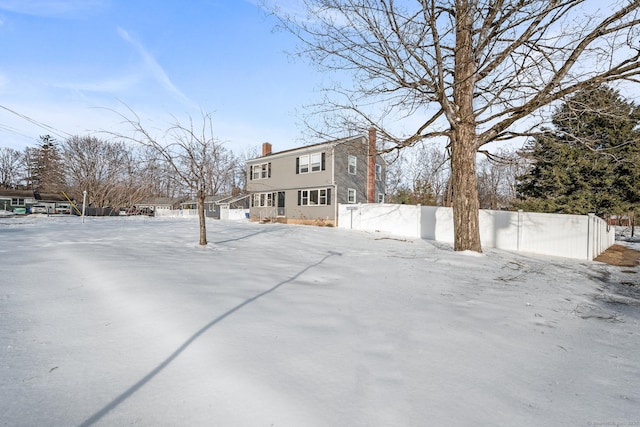 exterior space with fence and a chimney