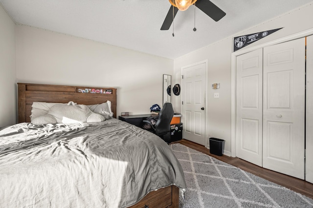 bedroom with ceiling fan, a closet, and dark wood-type flooring