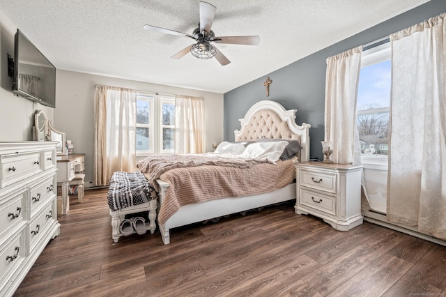 bedroom featuring a textured ceiling, ceiling fan, and dark wood-style flooring