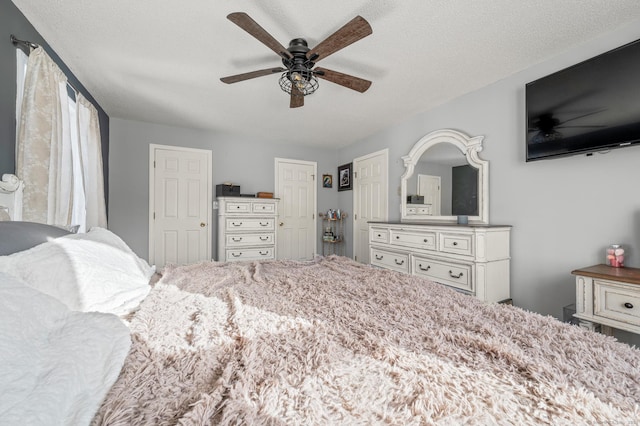 bedroom with a textured ceiling and a ceiling fan