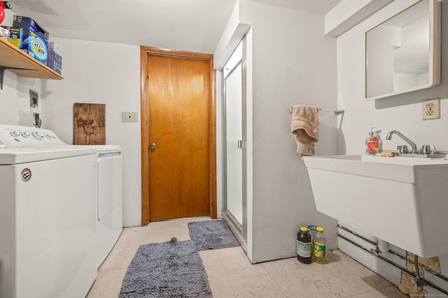 laundry area featuring laundry area, a sink, and washing machine and clothes dryer