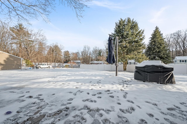 snowy yard with fence