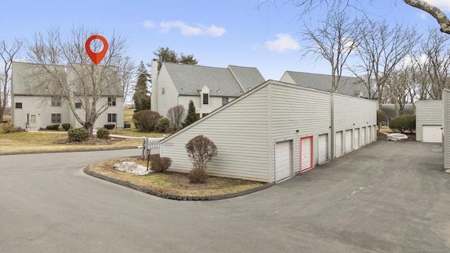 view of side of home featuring community garages