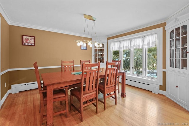 dining area featuring ornamental molding, baseboard heating, and light wood-style flooring