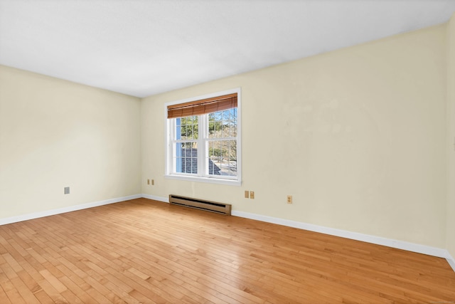 empty room with a baseboard radiator and light wood-type flooring