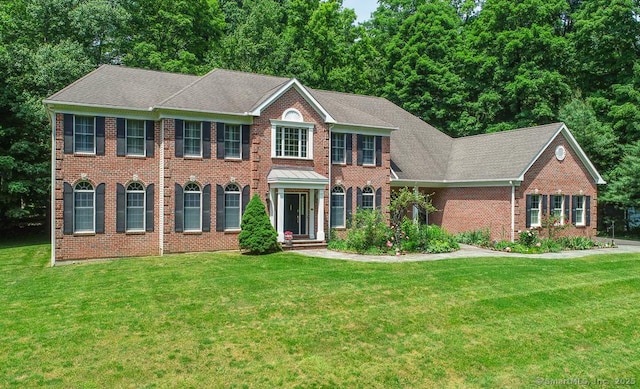 colonial-style house with a front yard