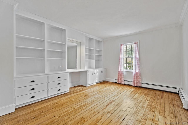 unfurnished bedroom featuring ornamental molding, light wood-type flooring, built in study area, and baseboards